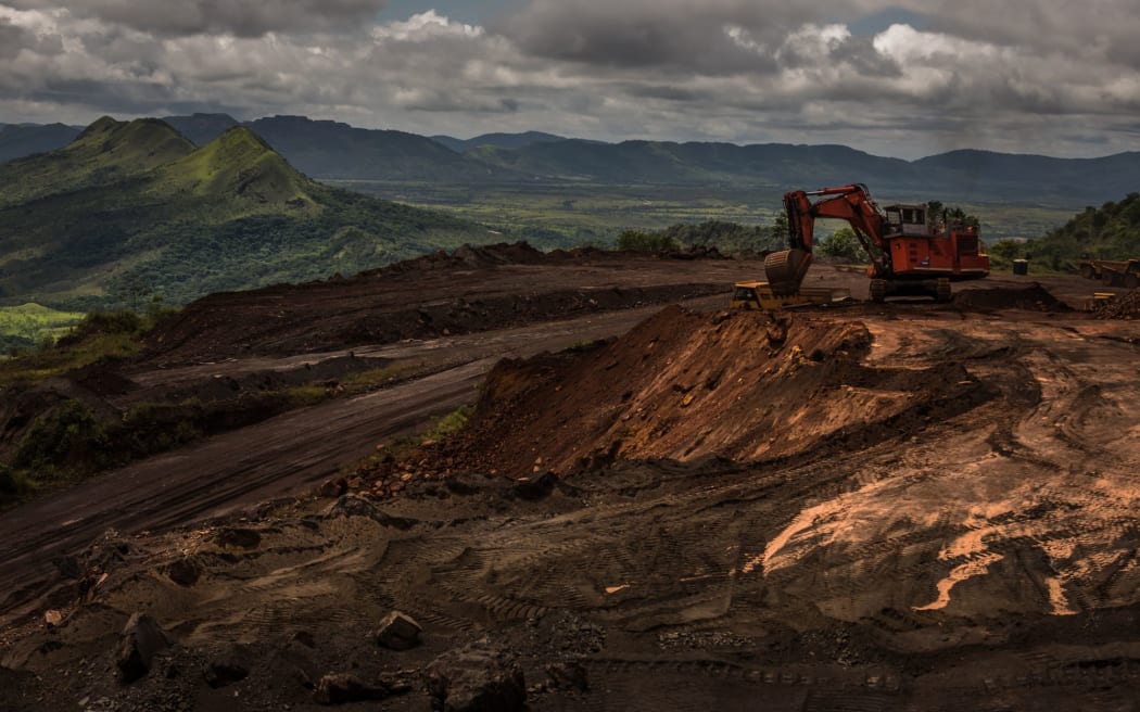 An excavator moves earth to a dump truck at a mining site of Venezuelan iron ore producer CVG Ferrominera Orinoco, on Bolivar Hill outside of Ciudad Piar, Venezuela, in July 2015.