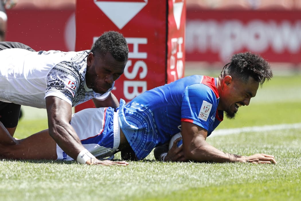 Samoa's Va'a Apelu Maliko scores a try against Fiji.