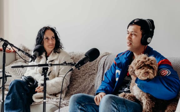 Moana Maniapoto sits next to her son Hikurangi Jackson, who is holding his dog, Rocky.