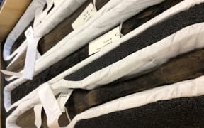 An image of some of the taonga to be returned, laid in cloth wrapping.