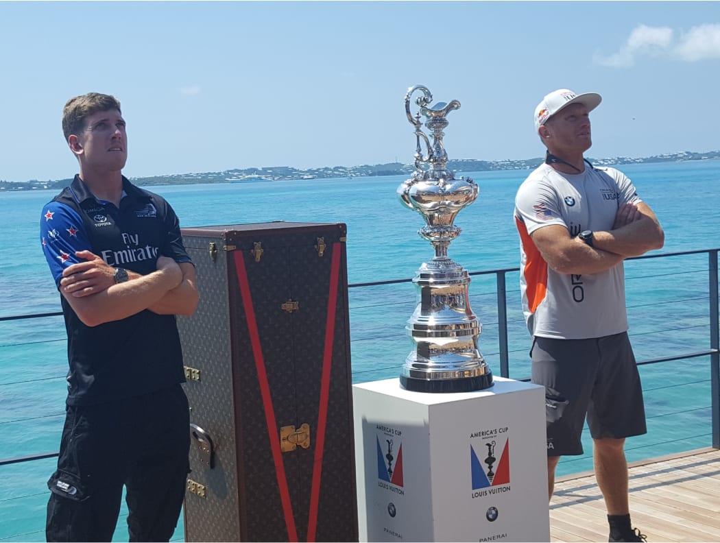 Team NZ helmsman Peter Burling, left, and Oracle Team USA's skipper Jimmy Spithill with the America's Cup in Bermuda.