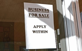sign in window saying business for sale