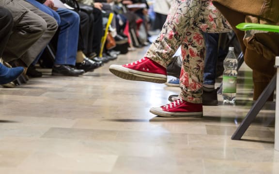 Many people in a waiting room to see a doctor