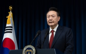 This handout photo taken and released on December 7, 2024 by the South Korean Presidential Office shows South Korea's President Yoon Suk Yeol delivering an address at the Presidential Office in Seoul. - South Korea's embattled President Yoon Suk Yeol stopped short of resigning on December 7 over his declaration of martial law, with a vote to impeach him hours away and mass street protests planned in Seoul. (Photo by Handout / South Korean Presidential Office / AFP) / RESTRICTED TO EDITORIAL USE - MANDATORY CREDIT "AFP PHOTO / SOUTH KOREAN PRESIDENTIAL OFFICE" - NO MARKETING NO ADVERTISING CAMPAIGNS - DISTRIBUTED AS A SERVICE TO CLIENTS / “The erroneous mention[s] appearing in the metadata of this photo by Handout has been modified in AFP systems in the following manner: [2024] instead of [2023]. Please immediately remove the erroneous mention[s] from all your online services and delete it (them) from your servers. If you have been authorized by AFP to distribute it (them) to third parties, please ensure...