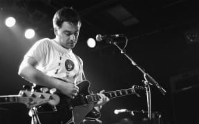 The Chills perform in Amsterdam in 1989, Martin Phillipps showing off his T-shirt power. (photo by Frans Schellekens/Redferns)