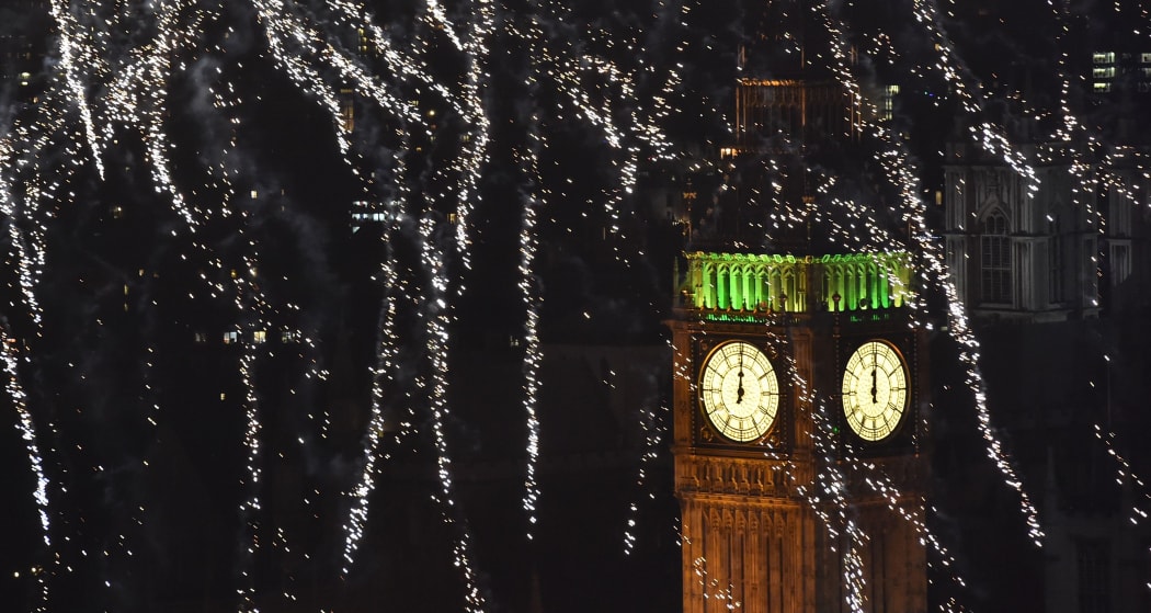 Fireworks explode above the Elizabeth Tower, also known as 'Big Ben', during celebrations in central London just after midnight on 1 January 2015.