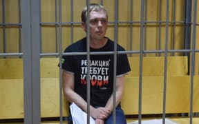 Russian investigative journalist Ivan Golunov, charged with attempted drug-dealing, sits inside a defendants' cage during a hearing at a court in Moscow on 8 June 2019.