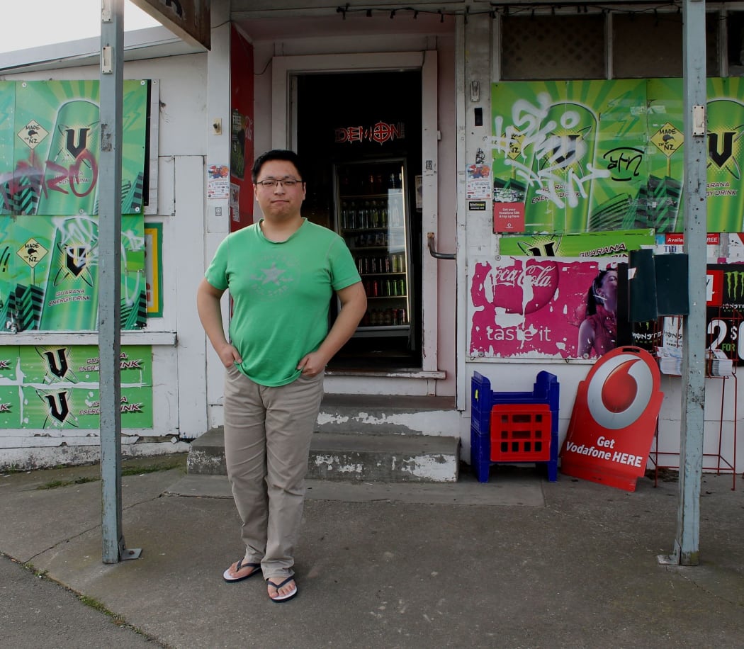 A photo of Adam Du outside the Burwood dairy he works for.