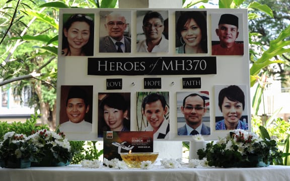 A poster showing cabin crew from Malaysia Airlines flight MH370 is displayed during a prayer at a school in Petaling Jaya on 8 March 2016.