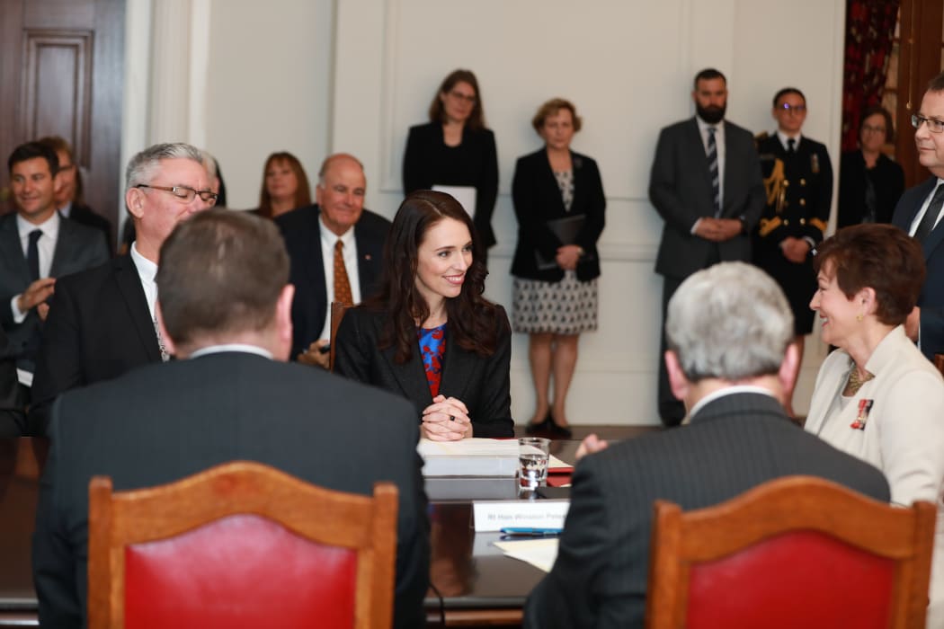 Jacinda Ardern, Winston Peters, and Dame Patsy Reddy seated for the swearing-in.