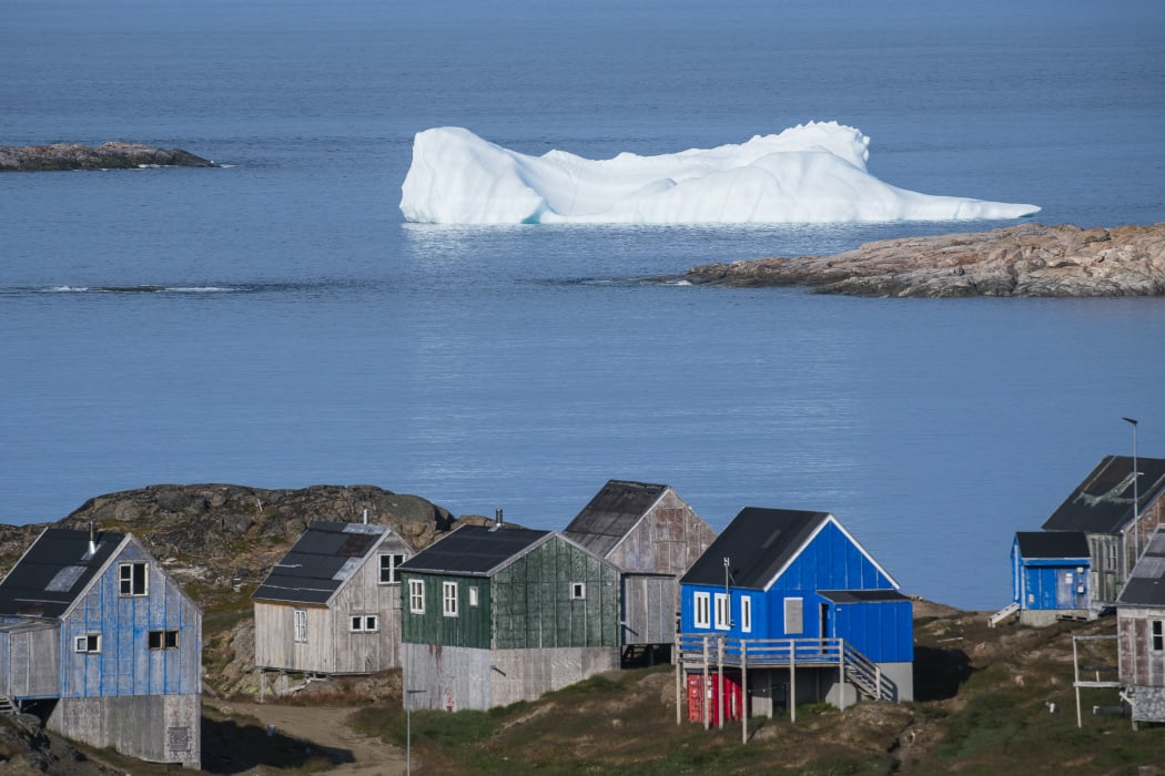 Icebergs float behind the town of Kulusuk in Greenland.