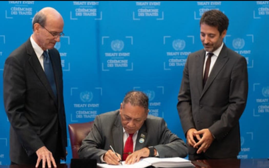 Solomon Islands Foreign Minister Peter Shanel Agovaka, middle, signing the TPNW at the UN Headquarters in New York. 24 September 2024