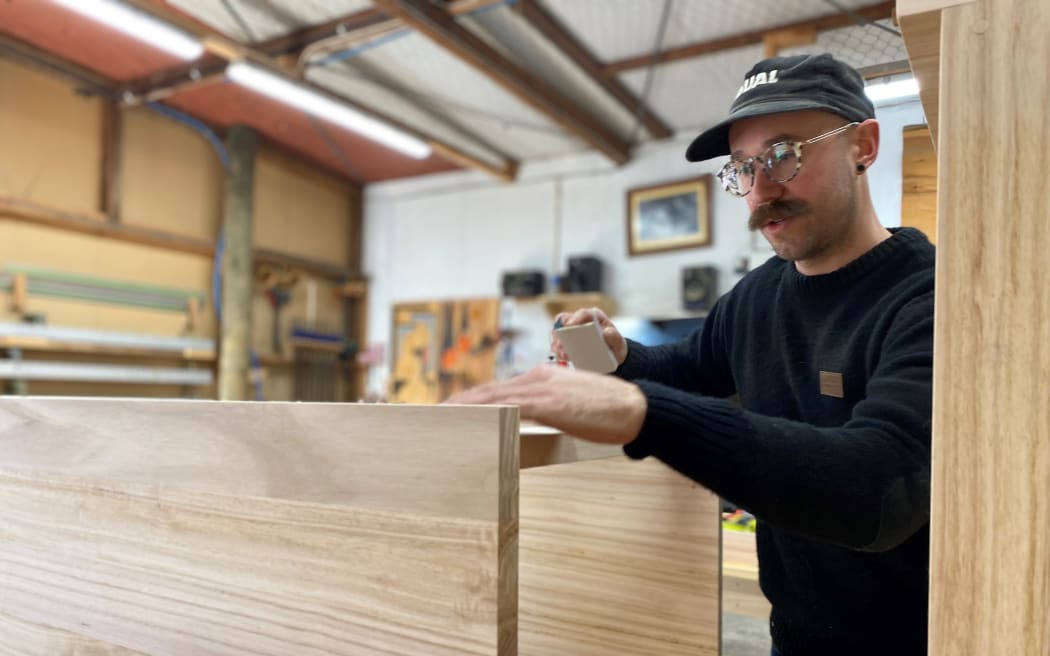 Chris the joiner sanding down a eucalyptus vanity in the joinery workshop.