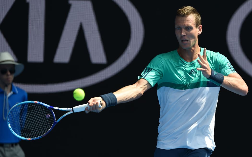 The Czech Tomas Berdych hits a return against Swiss great Roger Federer at the 2016 Australian Open on January 26, 2016. AFP PHOTO / GREG WOOD