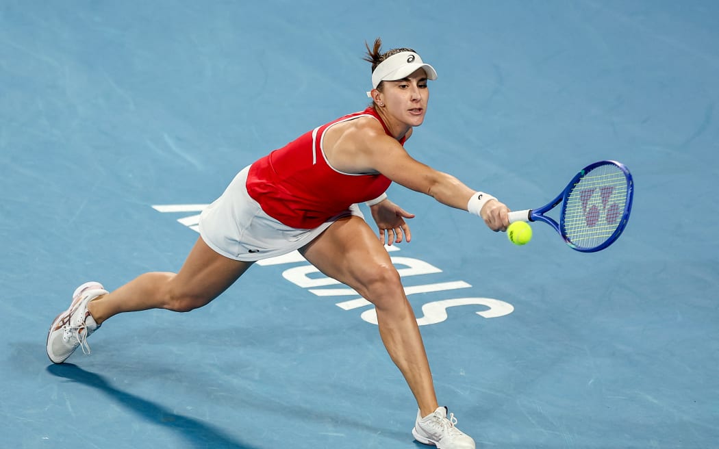 Switzerland's Belinda Bencic hits a return to Poland's Iga Swiatek during their women's singles match during the final at the United Cup tennis tournament in Sydney on January 11, 2026. (Photo by Izhar KHAN / AFP) / --IMAGE RESTRICTED TO EDITORIAL USE - STRICTLY NO COMMERCIAL USE--