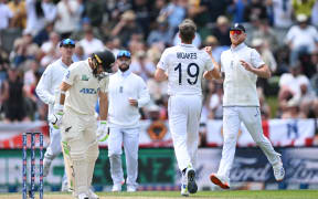 England bowler Chris Woakes celebrates with Ben Stokes the wicket of Tom Latham.