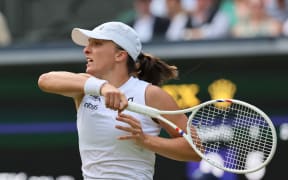 Iga Swiatek of Poland returns the ball to Caty McNally of the United States during the women's singles second-round match at Wimbledon, 3 July 2024. (Photo by Daisuke Urakami / The Yomiuri Shimbun via AFP)