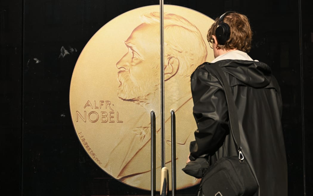 A person arrives at the door to the Swedish Academy ahead of the 2025 Nobel Prize in Literature at the Swedish Academy in Stockholm, Sweden, on October 9, 2025. (Photo by Jonathan Nackstrand / AFP)