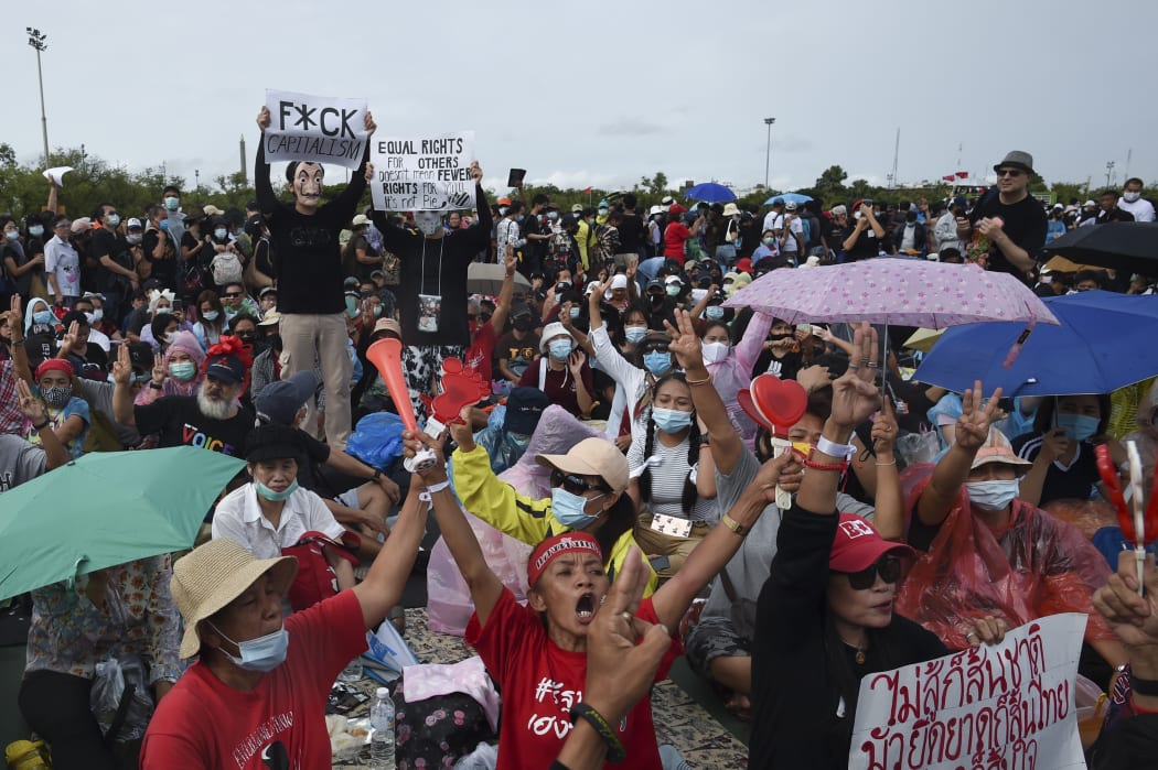An anti-government protester holds up a three-finger salute during an anti-government protest at the Royal Ground of Sanam Luang in Bangkok, Thailand, 19 September 2020.  (Photo by Anusak Laowilas/NurPhoto)