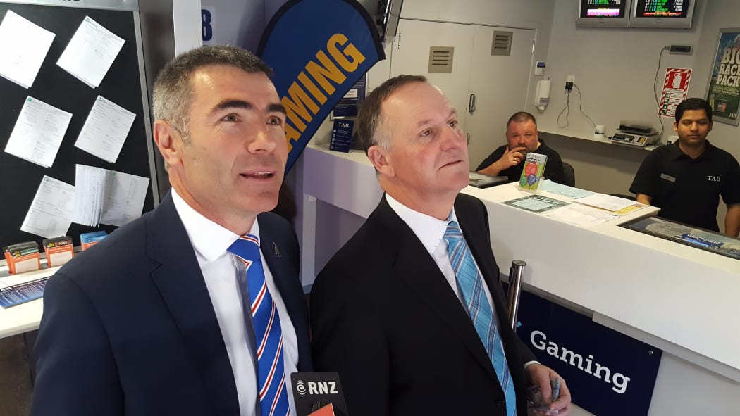 Prime Minister John Key (right) and Minister of Racing Nathan Guy (left) placing their bets on the Melbourne Cup at Trax Bar in Wellington