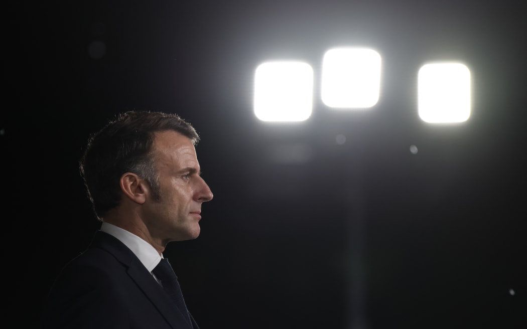 France's President Emmanuel Macron looks on whle addressing French troops during a ceremony at the 5th Cuirassier Regiment's base in Zayed Military City, near Abu Dhabi, on December 21, 2025. Macron arrived in the United Arab Emirates on December 21 to celebrate Christmas with French troops and to discuss bilateral ties with the Gulf state, as France hopes for more cooperation in its fight against drug trafficking. (Photo by Ludovic MARIN / AFP)