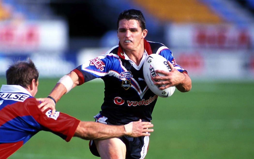 Ivan Cleary of the Warriors fends off a Knights player, New Zealand Warriors v Newcastle Knights