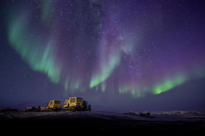 The aurora in Antarctica lights up a Hägglund vehicle.