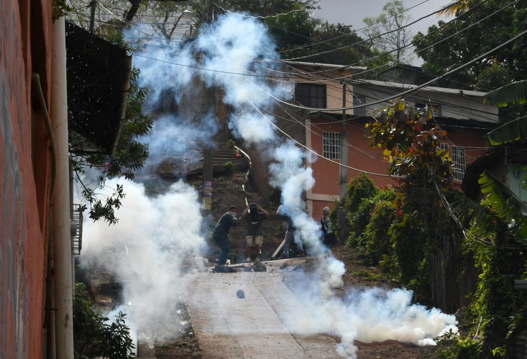 Supporters of presidential challenger Salvador Nasralla of the Honduran Opposition Alliance Against the Dictatorship, clash with  police in Tegucigalpa on Saturday, 20 January.