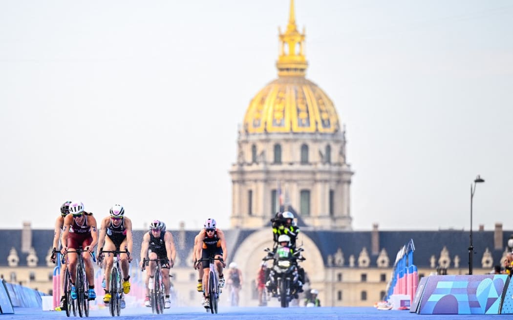 Hungarian Zsanett Kuttor-Bragmayer and French Cassandre Beaugrand ride on a bike during the women's individual triathlon race at the Paris 2024 Olympic Games, on Wednesday 31 July 2024 in Paris, France. The Games of the XXXIII Olympiad are taking place in Paris from 26 July to 11 August. The Belgian delegation counts 165 athletes competing in 21 sports. BELGA PHOTO JASPER JACOBS (Photo by JASPER JACOBS / BELGA MAG / Belga via AFP)