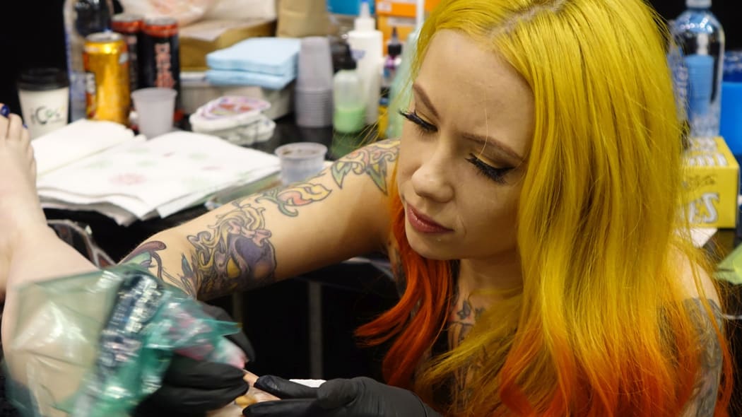 New York tattooist Megan Massacre works on a client.