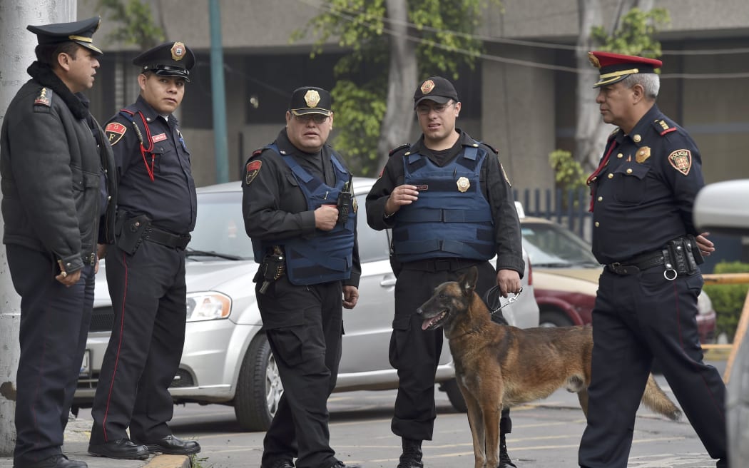 Police patrol outside the building where  Jose Luis Abarca and his wife Maria de Los Angeles Pineda are detained.