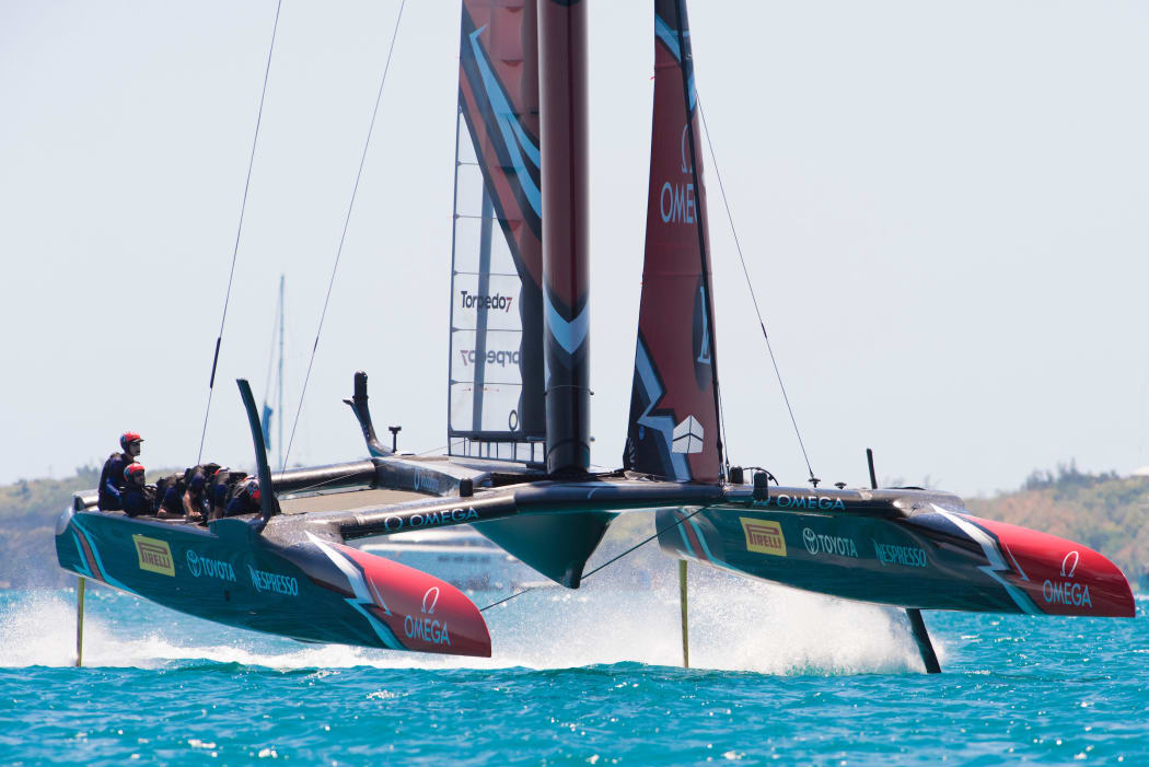 Emirates Team New Zealand rounds the top mark ahead of Oracle Team USA in race four on day two of the America's Cup.