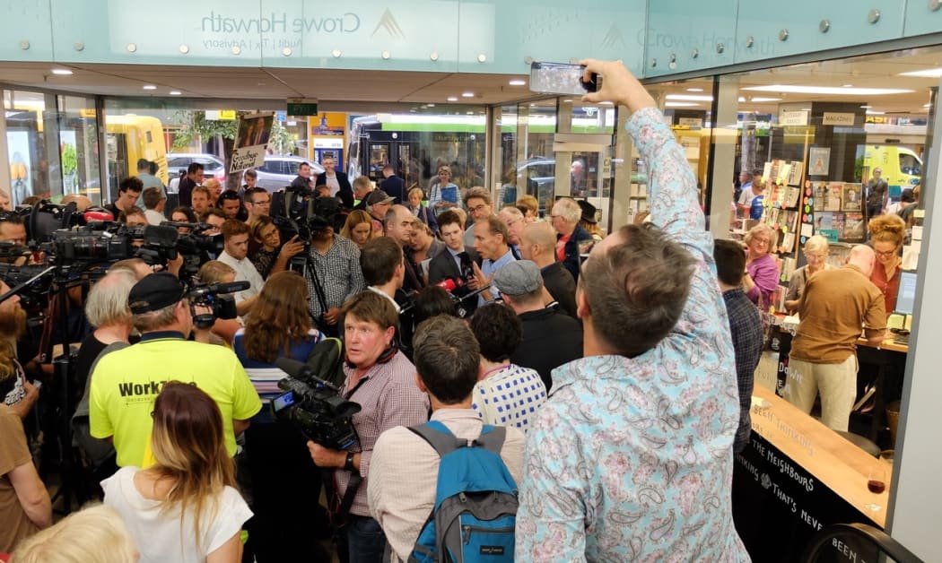Nicky Hager and Jon Stephenson in a media scrum at the launch of 'Hit and Run.'
