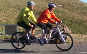 CERA boss Roger Sutton and Christchurch City Council boss Karleen Edwards on a tandem bike to mark the re-opening of part of Summit Road in July.