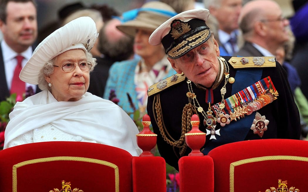 (FILES) In a file picture taken on June 3, 2012 shows Britain's Queen Elizabeth II (L) and Prince Philip, Duke of Edinburgh (R), standing onboard the Spirit of Chartwell during the Thames Diamond Jubilee Pageant on the River Thames in London.