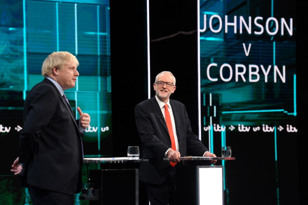 Britain's Prime Minister Boris Johnson (L) and Britain's Labour Party leader Jeremy Corbyn (R) as they debate on the set of "Johnson v Corbyn: The ITV Debate" in Salford, north-west England. - Britain will go to the polls on December 12, 2019 to vote in a pre-Christmas general election.