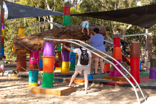 A family plays on a playground made by using reclaimed and salvaged material in Sydney