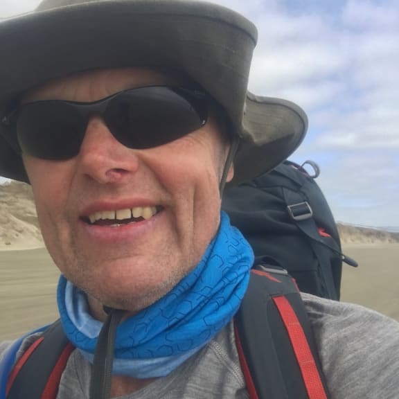 A close up shot of Bruce Hopkins walking on 90 Mile Beach.