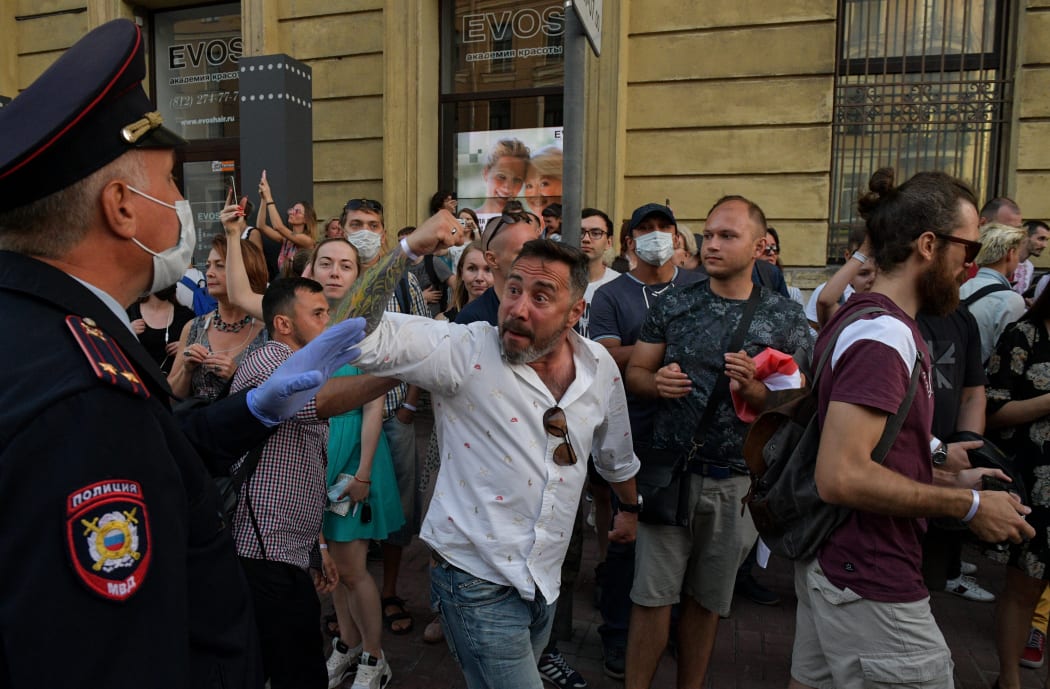 People react outside the Belarusian embassy after a polling station was closed during Belarus' presidential election.