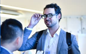 A man tries on smart glasses capable of real-time translation.