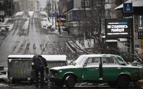 An armed man stands at a road block in downtown Kyiv on March 1, 2022.
