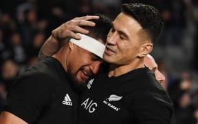 Vaea Fifita is hugged by Sonny Bill Williams after scoring a try.