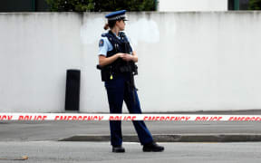 A police officer secures the area in front of the Masjid al Noor mosque on Friday.