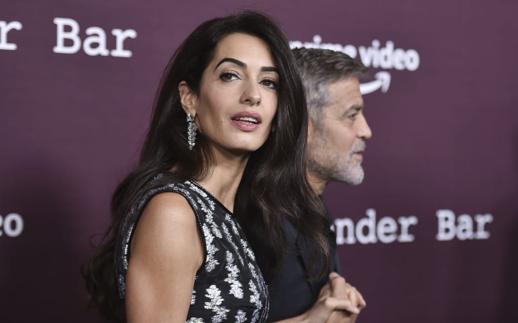 FILE - Amal Clooney, left, and George Clooney arrive at a screening of "The Tender Bar," Oct. 3, 2021, at the Directors Guild of America in Los Angeles. Amal Clooney is one of the legal experts who recommended that the world's top war crimes court seek arrest warrants for Israeli Prime Minister Benjamin Netanyahu and leaders of the militant Hamas group, Clooney announced Monday, May 20, 2024. (Photo by Richard Shotwell/Invision/AP, File)
