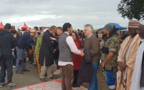 A Muslim leader greets lawyer Moana Jackson at a powhiri at Ihumātao.