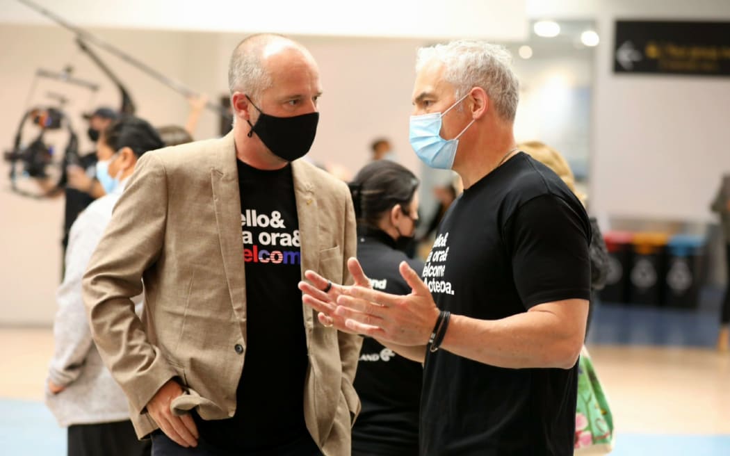 Travellers reconnect at Auckland airport as vaccinated international tourists from visa-waiver countries return to New Zealand, 2 May 2022.