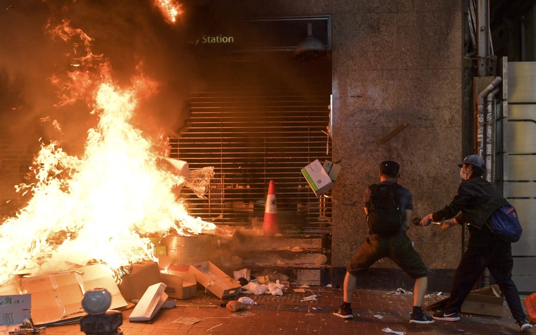 Protesters burn items at the Causeway Bay metro station entrance in Hong Kong on October 4, 2019, as people hit the streets after the government announced a ban on facemasks.