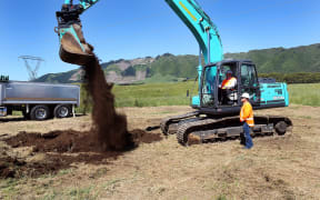 Gerry Brownlee turns the first sod at the site on Monday.