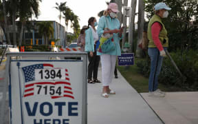 People stand in line to vote at the Morton and Barbara Mandel Recreation Center on November 03, 2020 in Palm Beach, Florida.