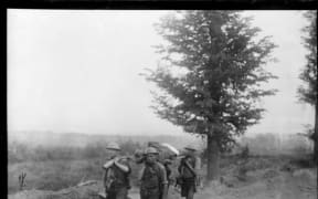 New Zealanders carrying a wounded soldier on a stretcher, near Messines, Belgium, during World War 1.